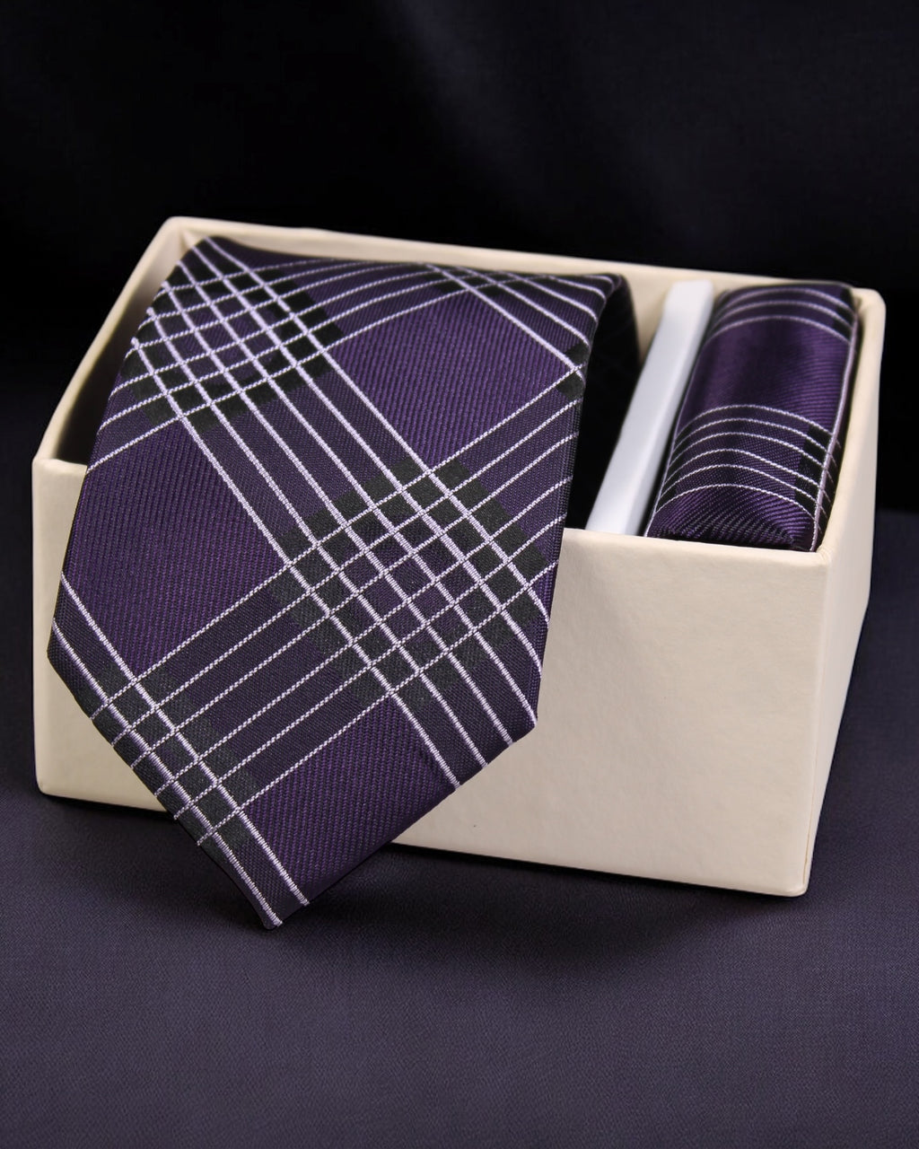 Purple plaid tie and pocket square set in a white box on a dark background Tie Benon