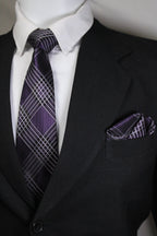 Close-up of a black suit with a white shirt and purple plaid tie tie benon