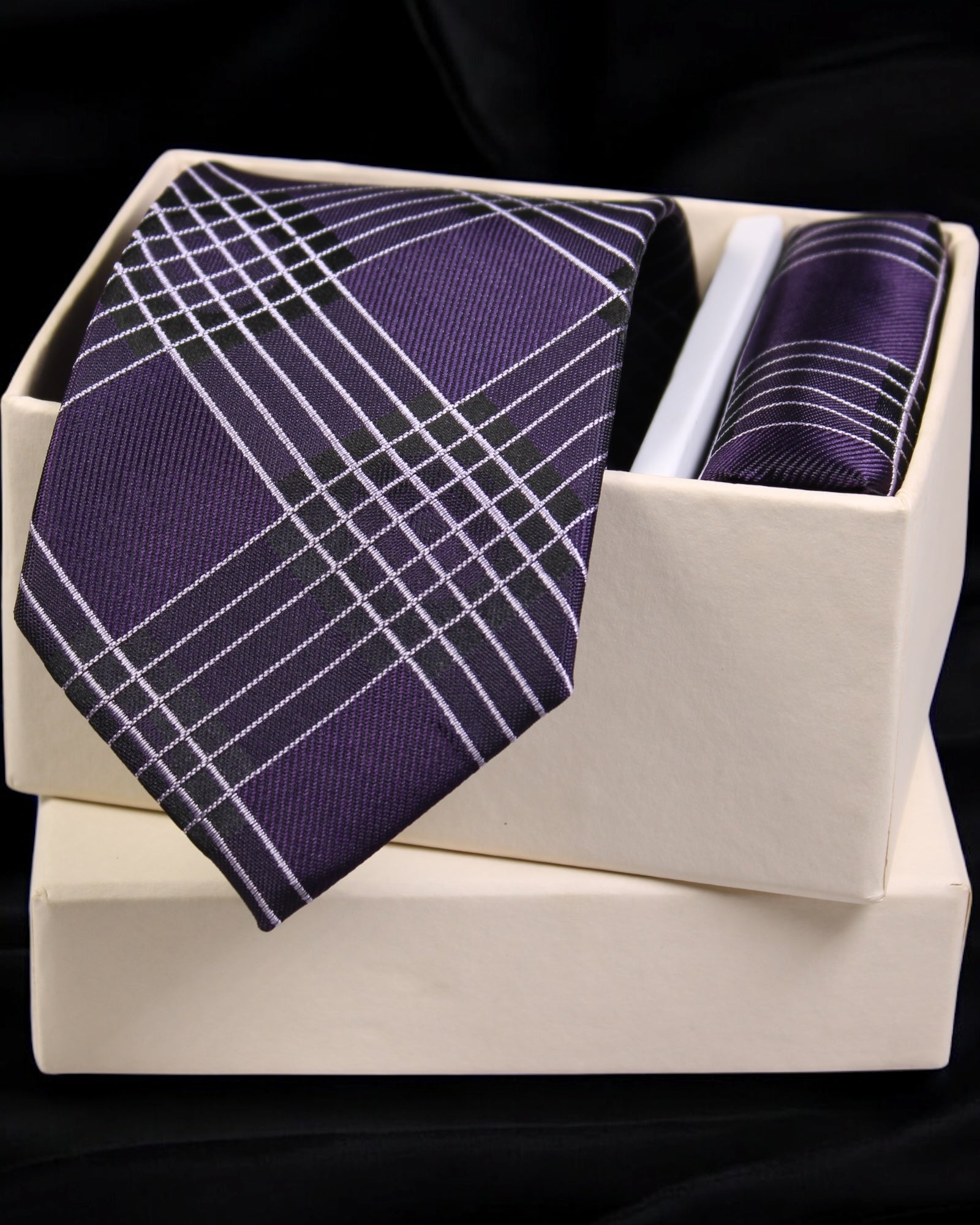 Purple plaid tie and pocket square set in a white box on a black background Tie Benon