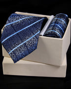 Blue patterned tie and pocket square set in a white box on a black background tie Benon
