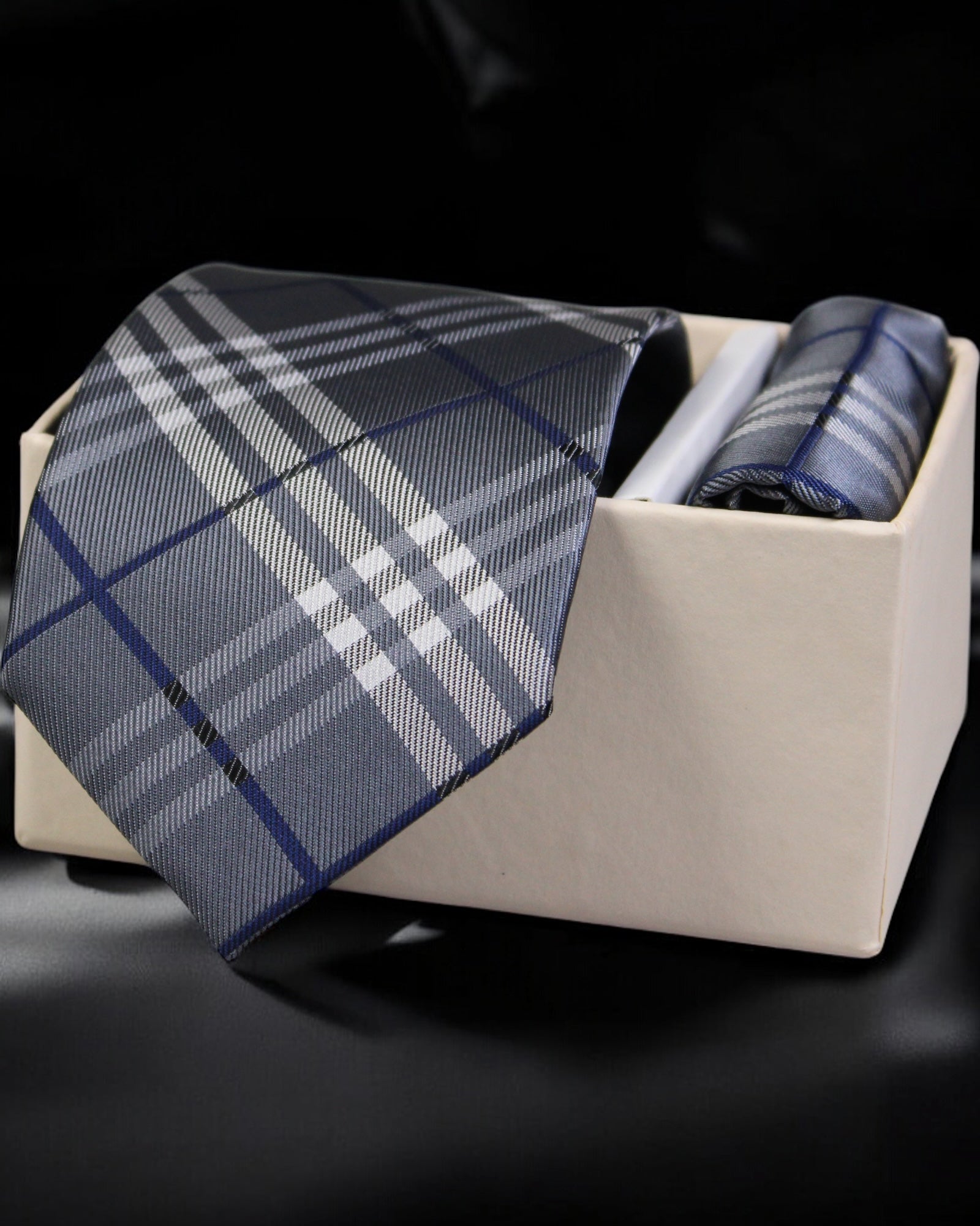 Plaid tie and pocket square set in a box on a black background Tie Benon