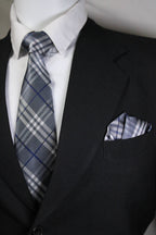 Close-up of a plaid tie and pocket square with a suit jacket Tie benon