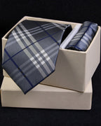 Plaid tie and pocket square set in a white box on a black background Tie Benon