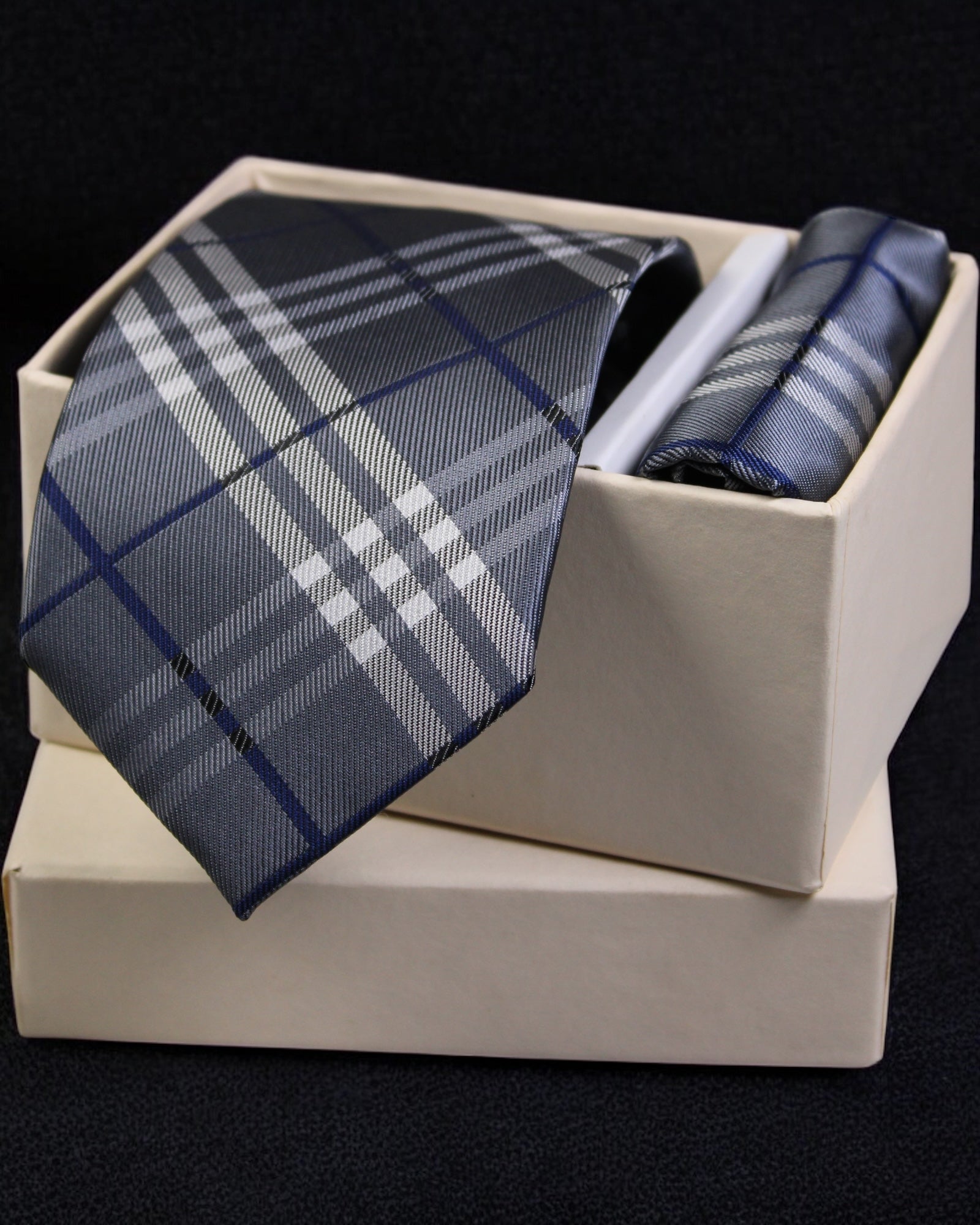 Plaid tie and pocket square set in a white box on a black background Tie Benon