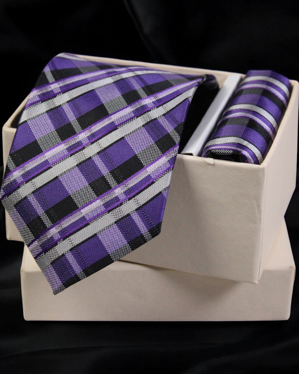 Purple plaid tie and pocket square set on a white box with a black background tie benon