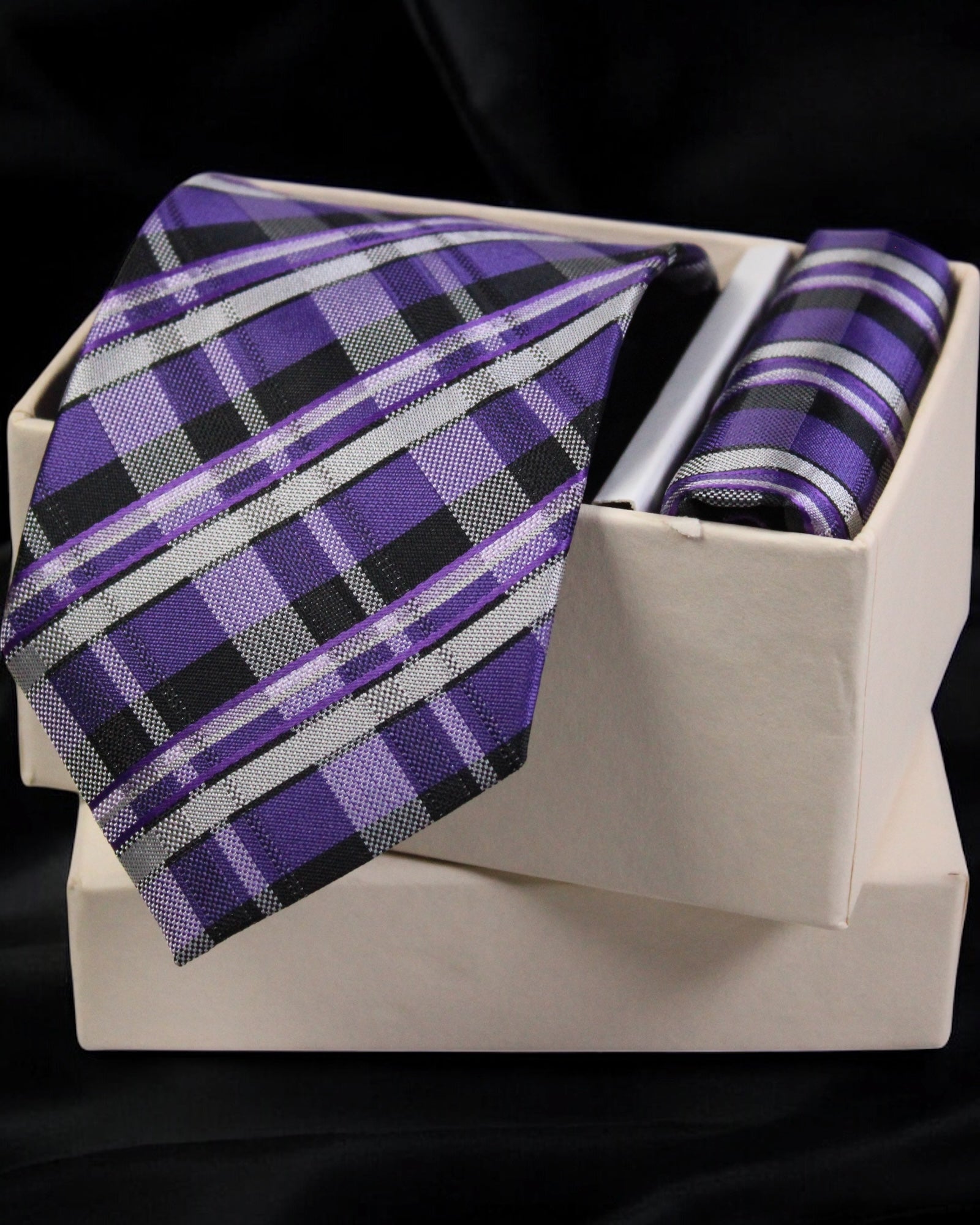Purple plaid tie and pocket square set on a white box with a black background tie benon