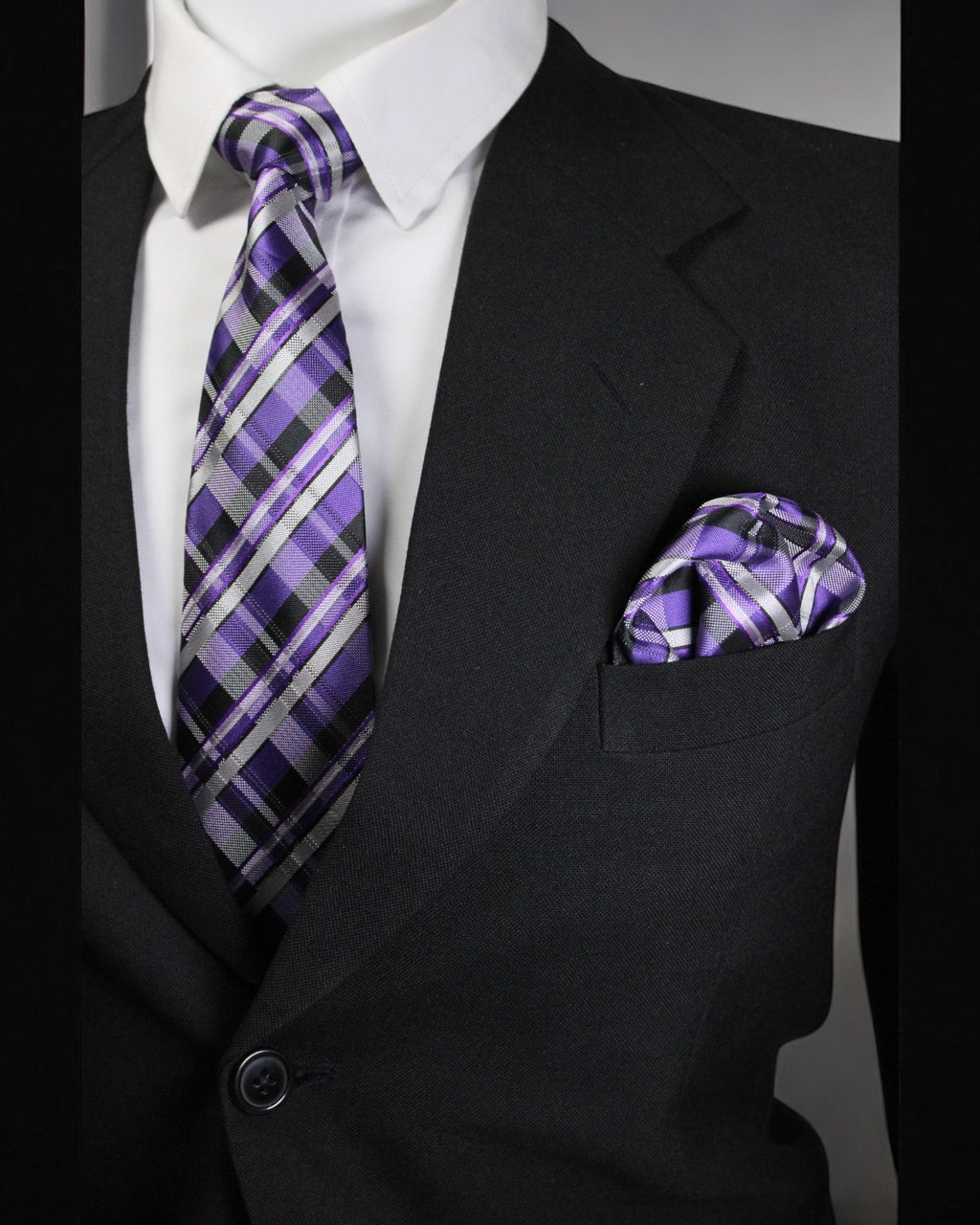 Black suit with a purple plaid tie and pocket square on a gray background Tie Benon