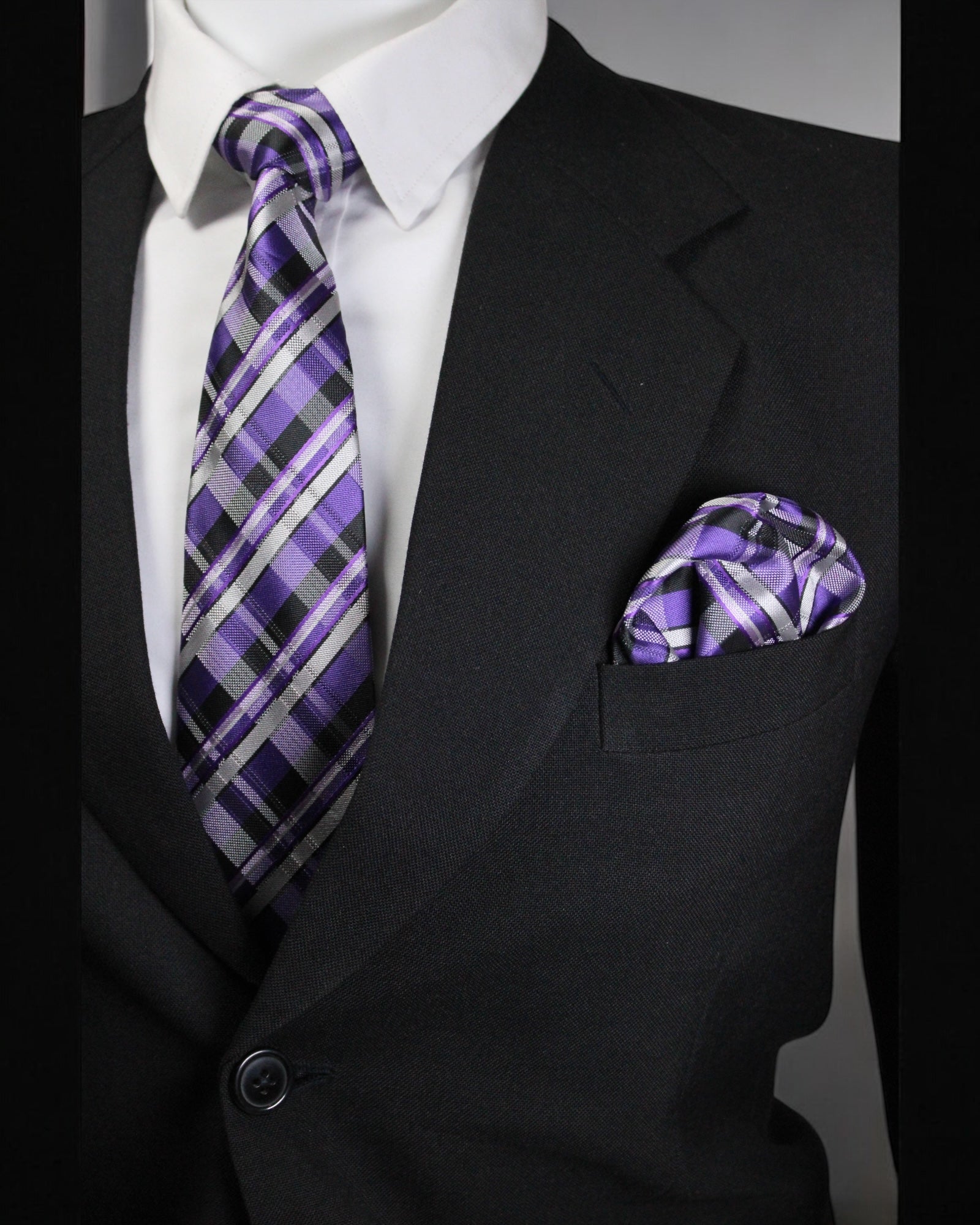 Black suit with a purple plaid tie and pocket square on a gray background Tie Benon