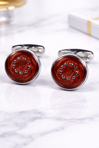 Wooden cufflinks with silver accents on a marble surface