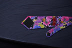 Colorful floral-patterned pouch on a dark fabric background