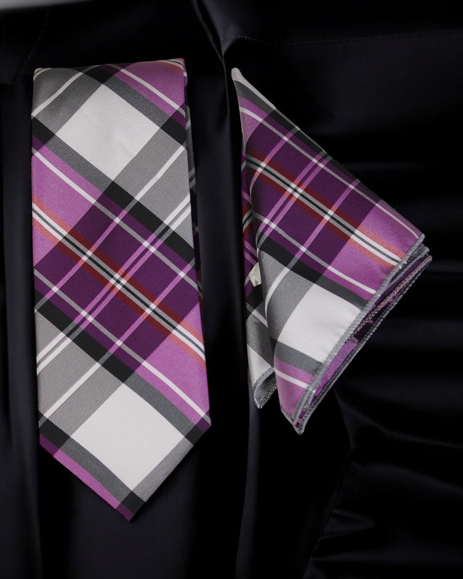 Plaid tie and pocket square set on a black fabric background Tie Benon