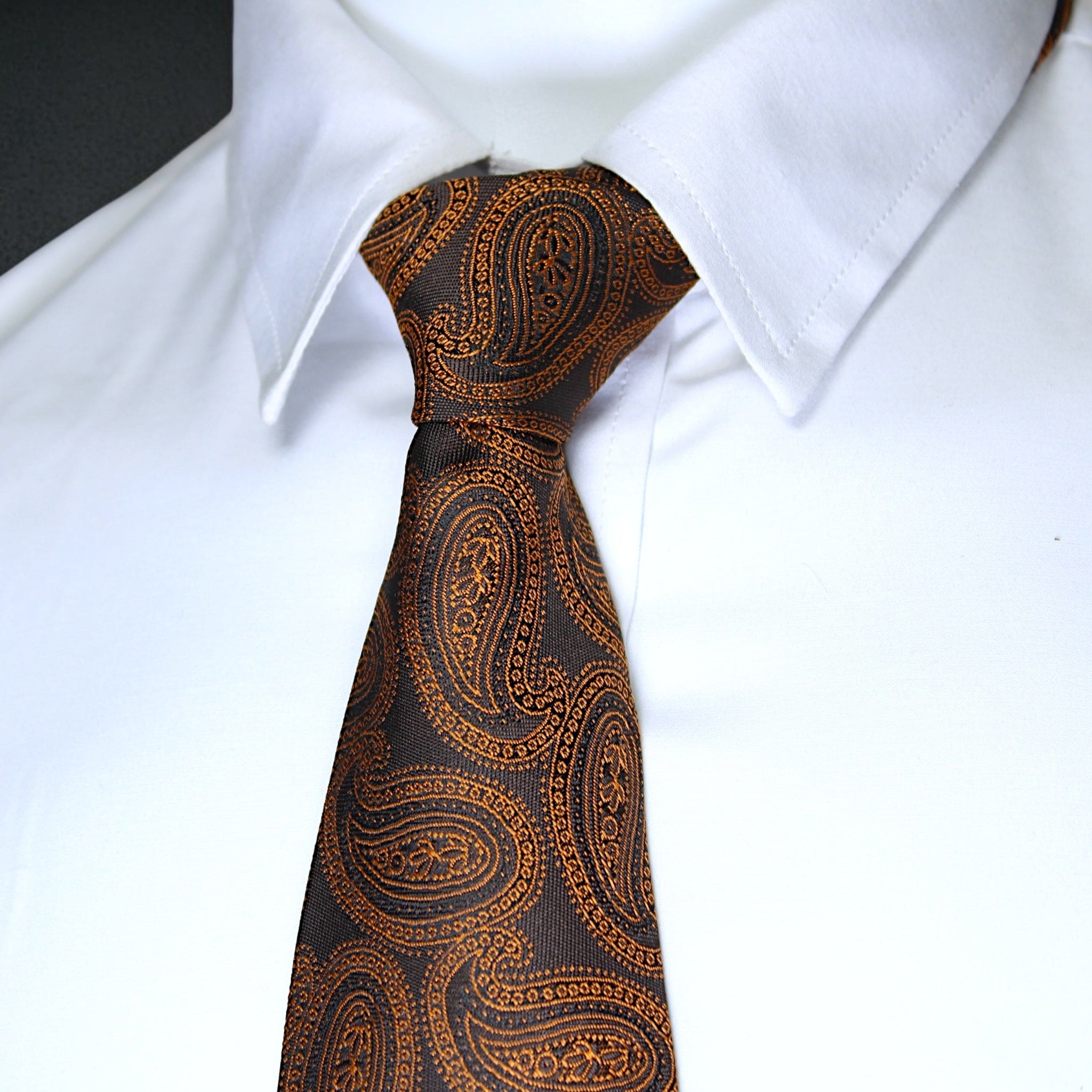 Brown paisley tie on a white shirt
