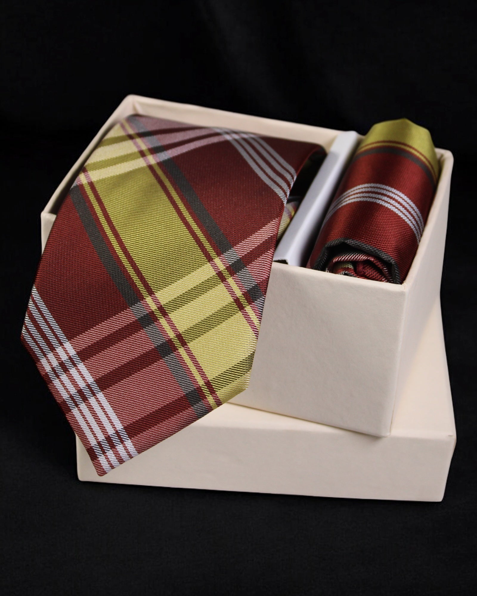 Plaid tie and pocket square set in a white box on a black background Tie Benon