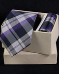 Plaid tie and pocket square set in a box on a black background