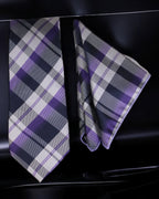 Plaid tie and pocket square set on a black background