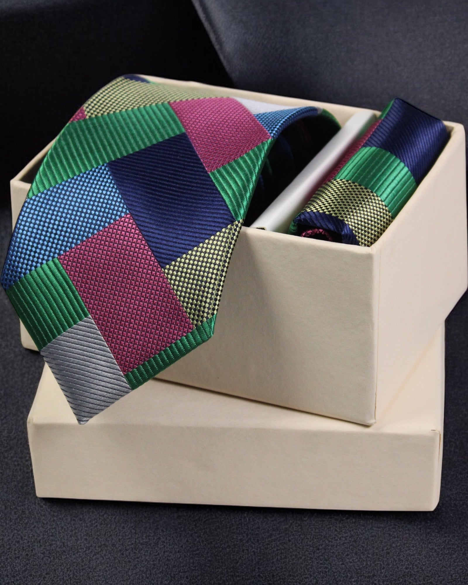 Colorful geometric patterned tie in a box on a dark background Tie Benon