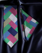 Colorful geometric-patterned tie and pocket square on a dark background Tie Benon