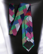 Colorful geometric patterned tie on a black surface Tie Benon