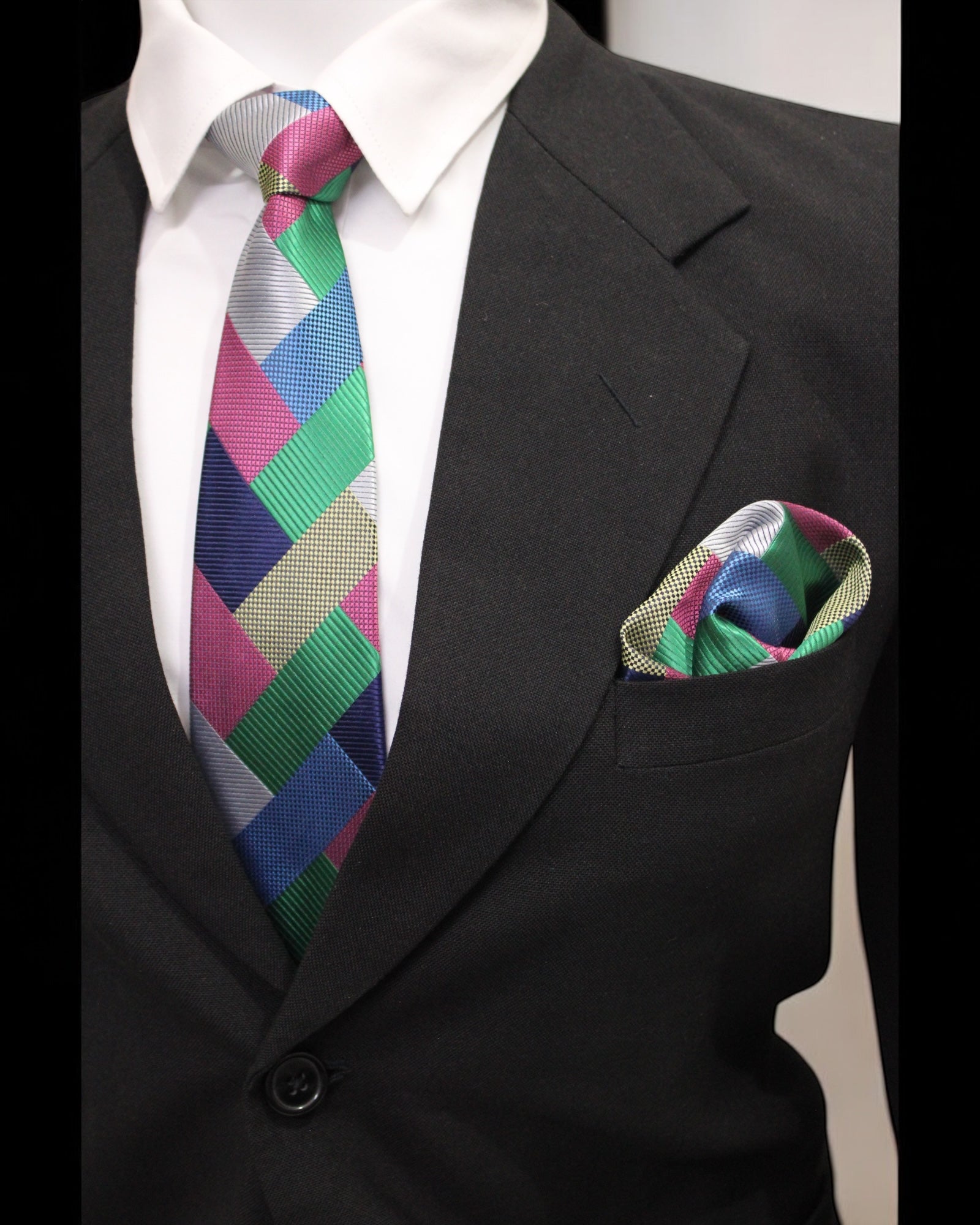 Black suit with a colorful tie and pocket square on a neutral background Tie Benon