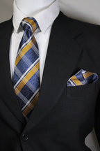 Striped tie hanging out of a suit pocket with a white shirt underneath Tie Benon