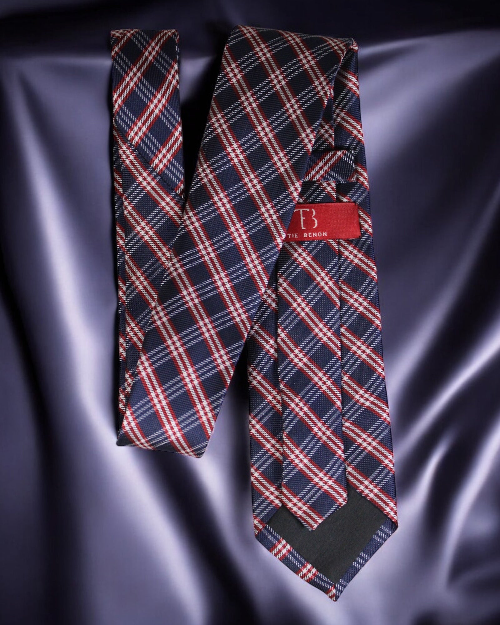 Plaid tie with a brand label on a satin background Tie Benon