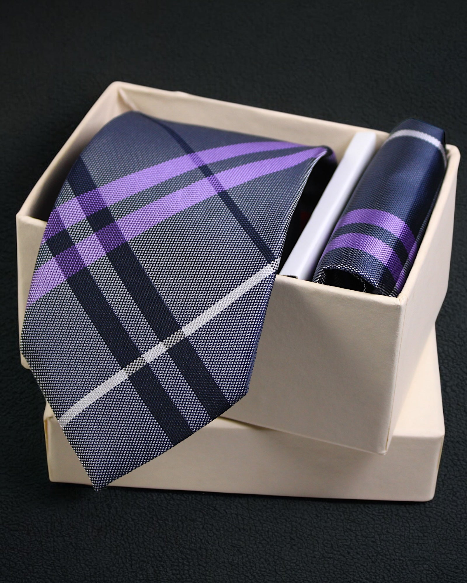 Plaid tie and pocket square set in a box on a black background Tie Benon