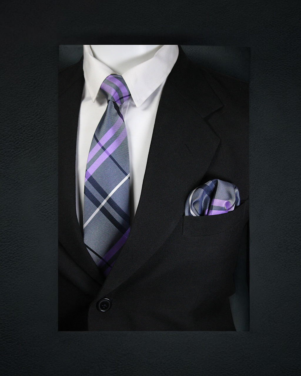 Black suit with a white shirt, purple and gray striped tie, and matching pocket square on a dark background. tie Benon