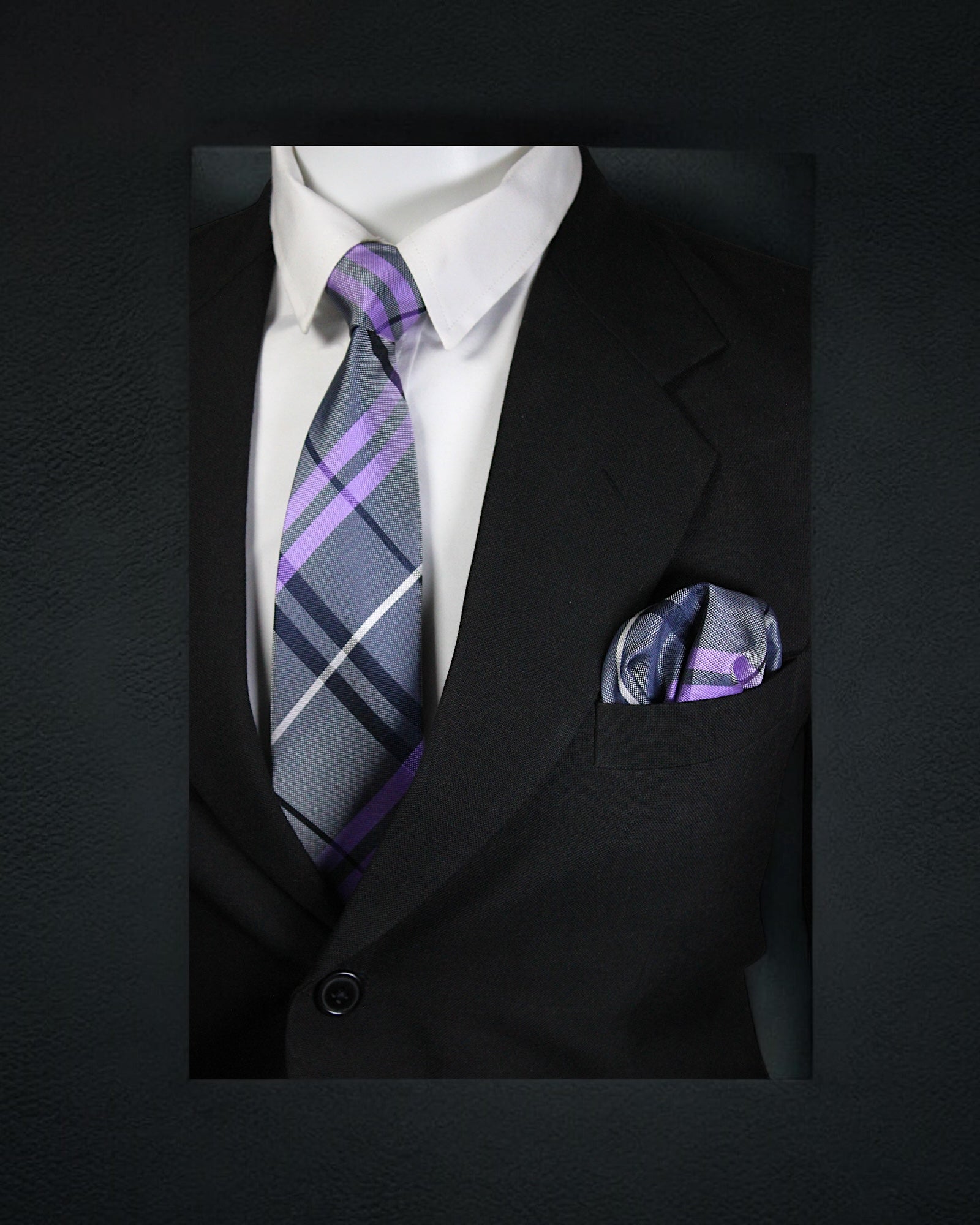 Black suit with a white shirt, purple and gray striped tie, and matching pocket square on a dark background. tie Benon