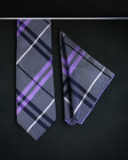 Plaid tie and pocket square set on a black background