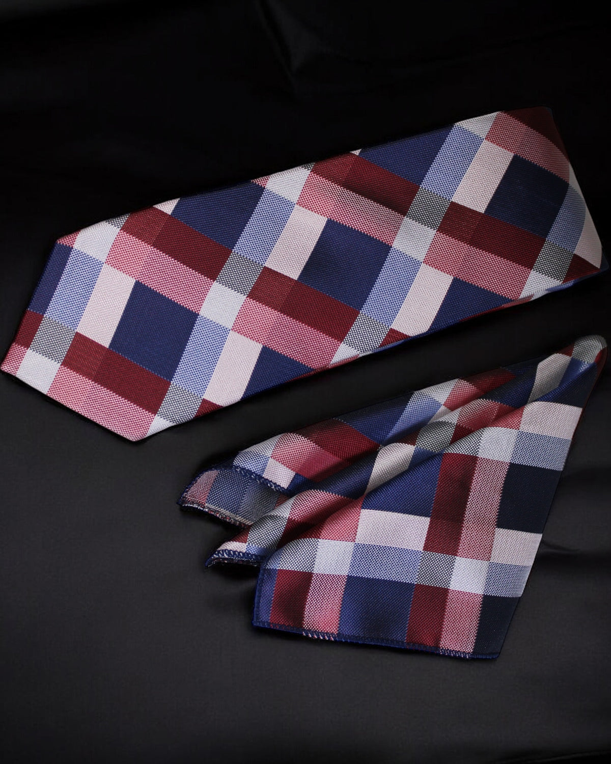 Plaid tie and pocket square set on a black background tie benon