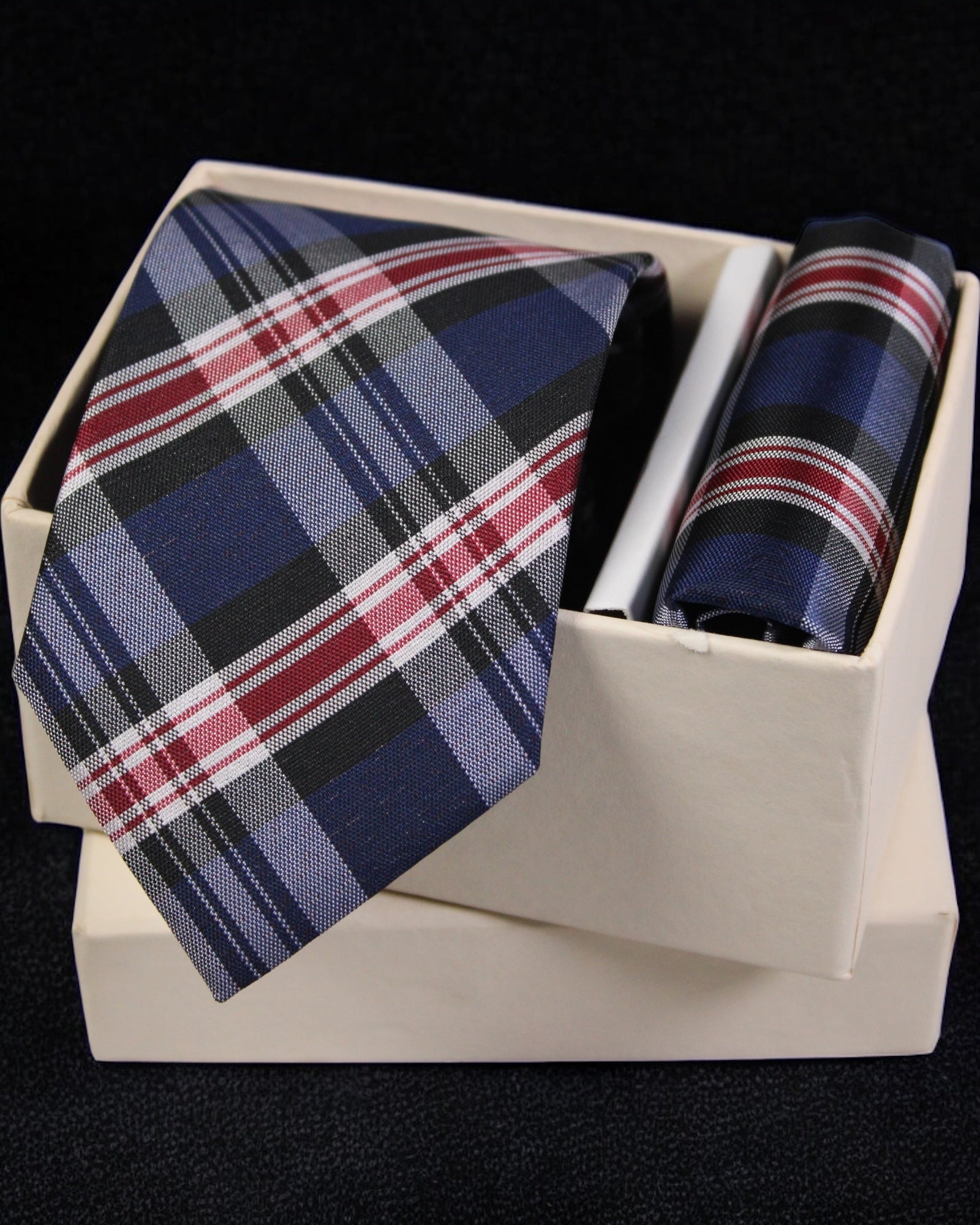 Plaid tie and pocket square set in a white box on a black background Tie Benon