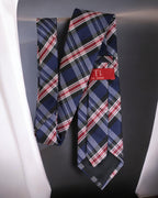 Plaid tie with a red label on a dark background Tie Benon