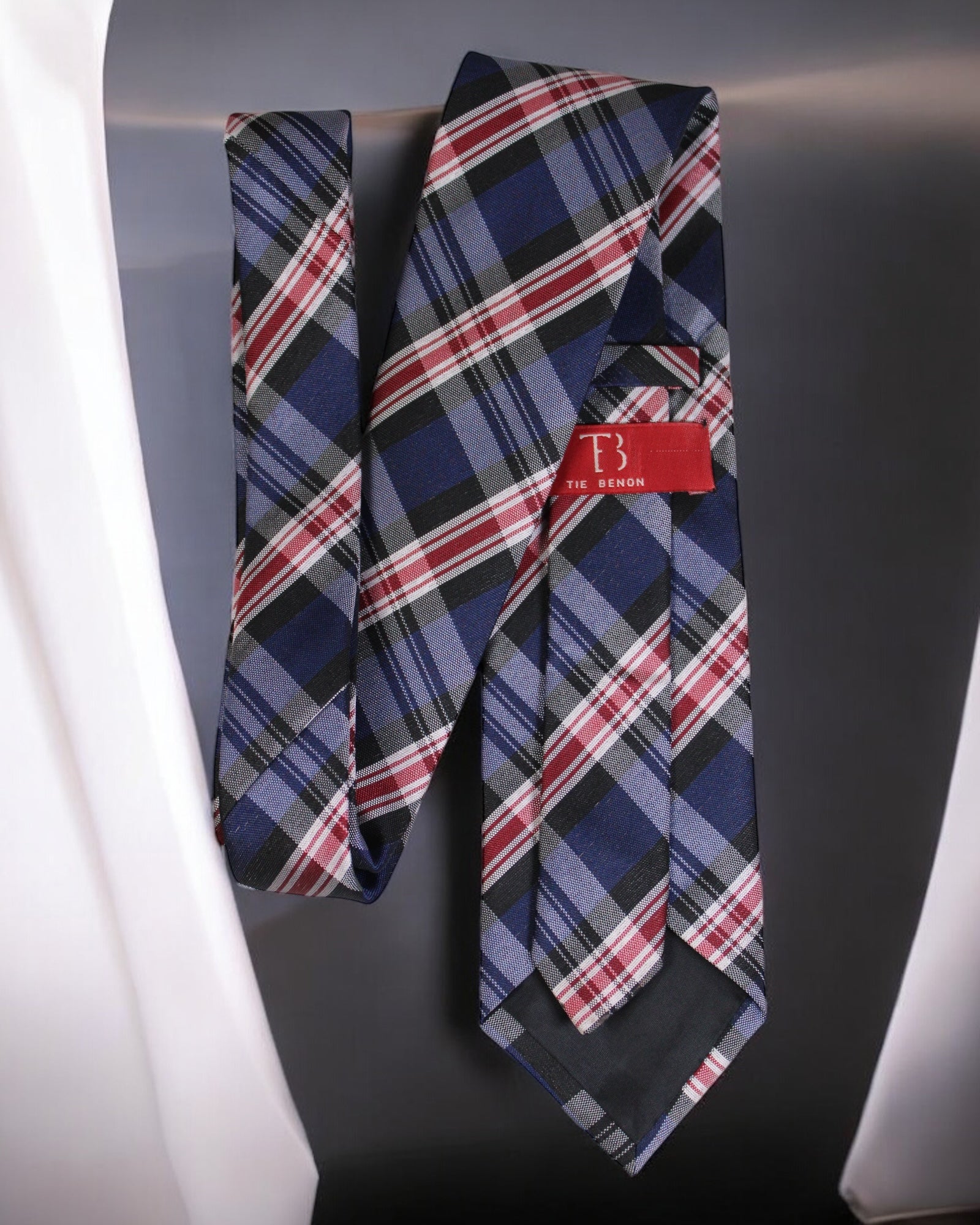 Plaid tie with a red label on a dark background Tie Benon