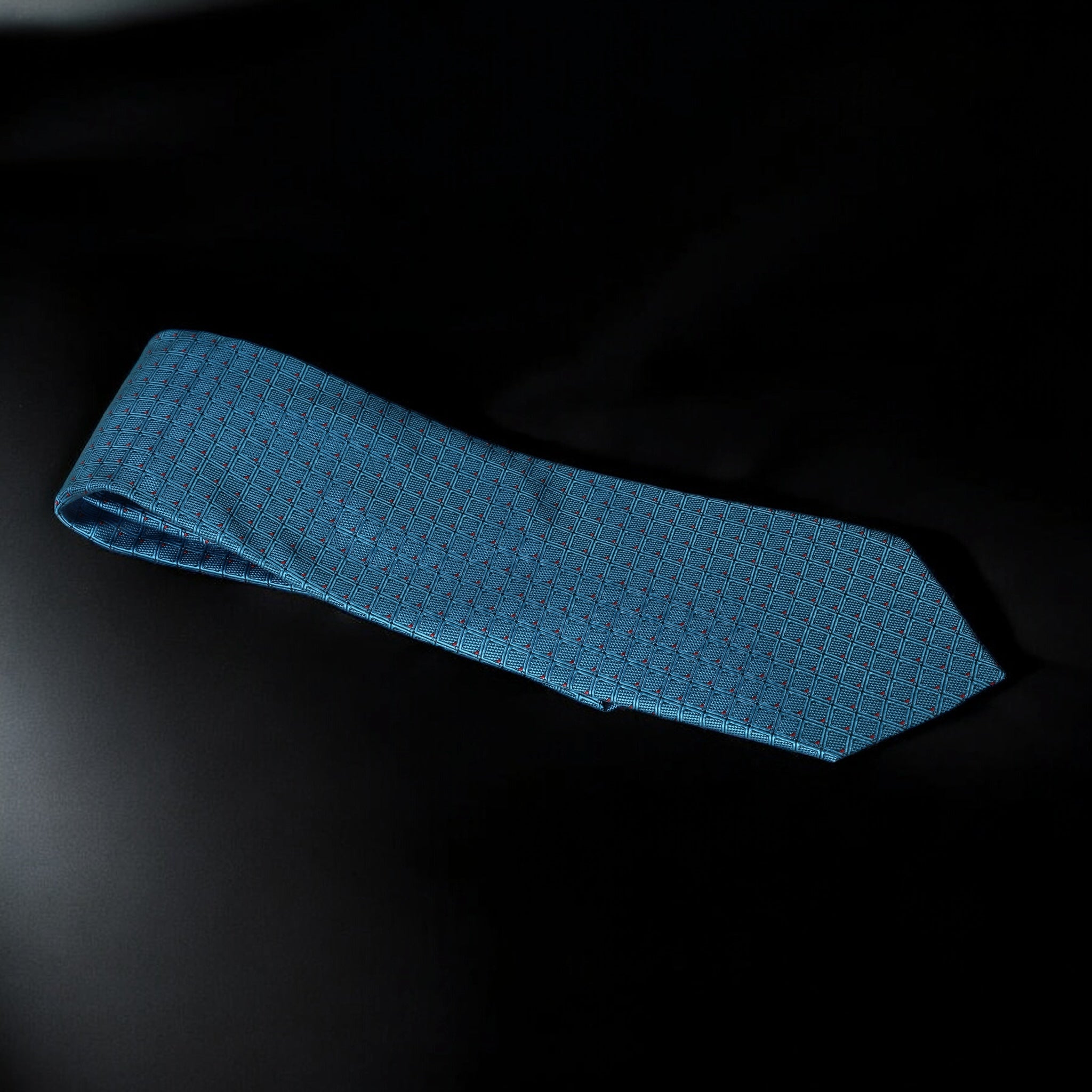 Blue textured tie on a black background