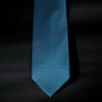 Blue patterned tie on a black background