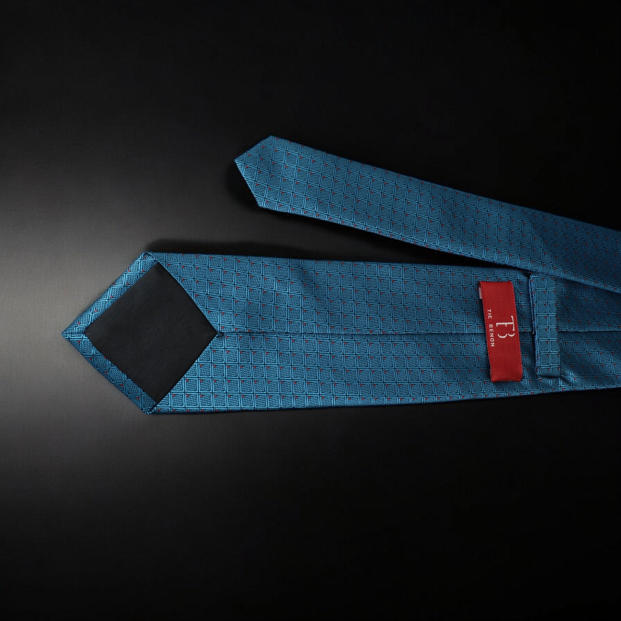 Blue tie with a red label on a black background