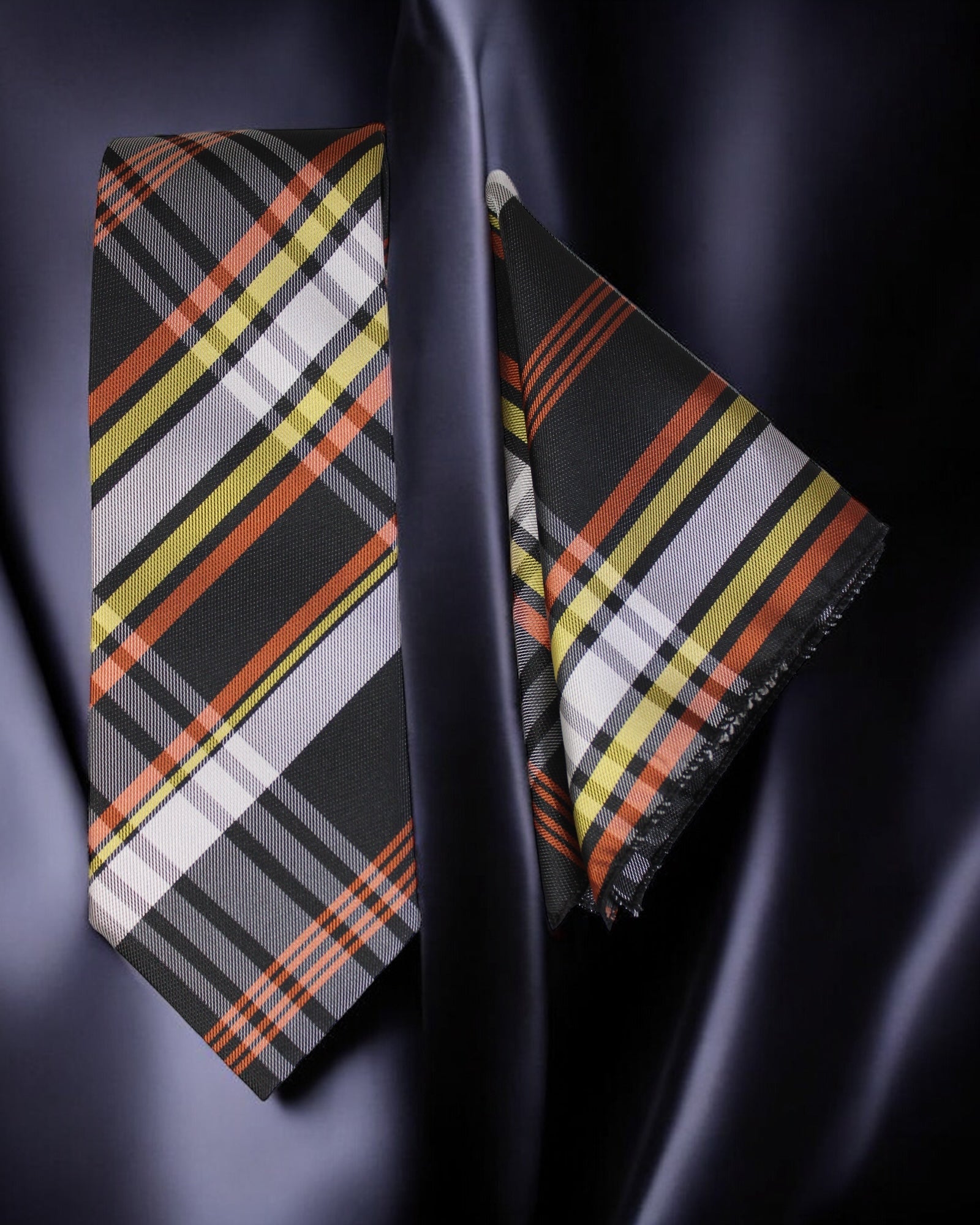 Plaid tie and pocket square set on a dark fabric background Tie Benon