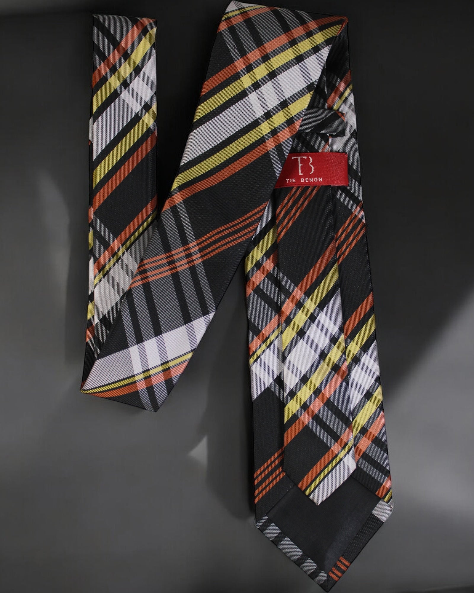 Plaid tie with a red tag on a gray background Tie Benon