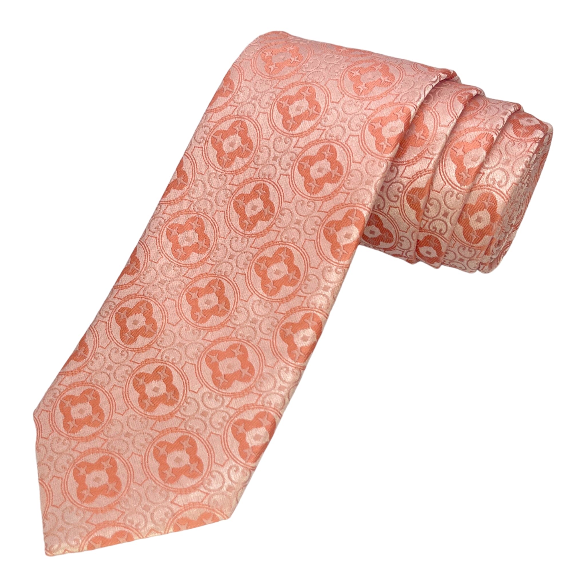 A peach-colored tie and pocket square with a geometric pattern, laid out on a plain surface.