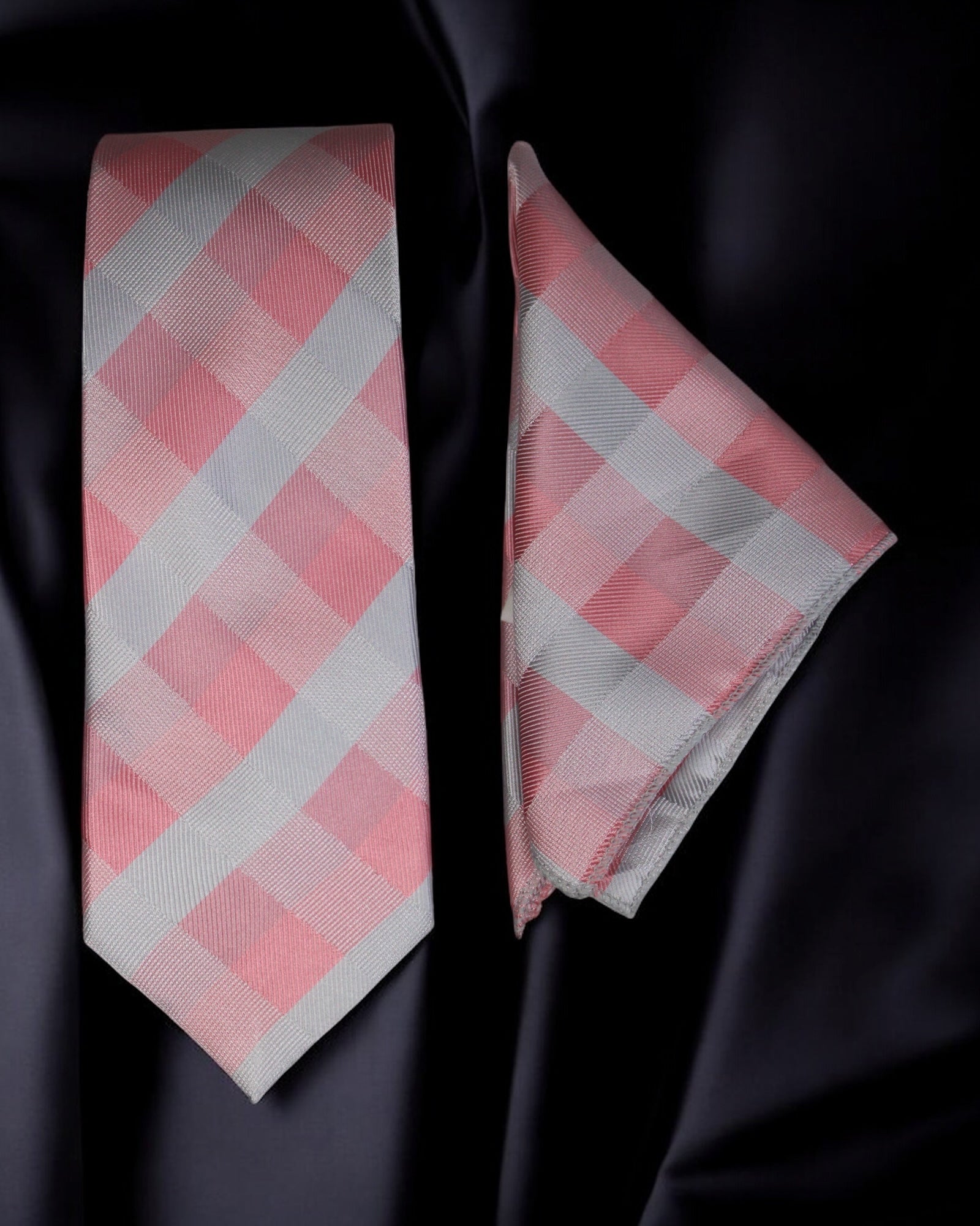 Pink and white checkered tie and pocket square on a black background