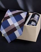 Plaid tie in a beige box on a dark background