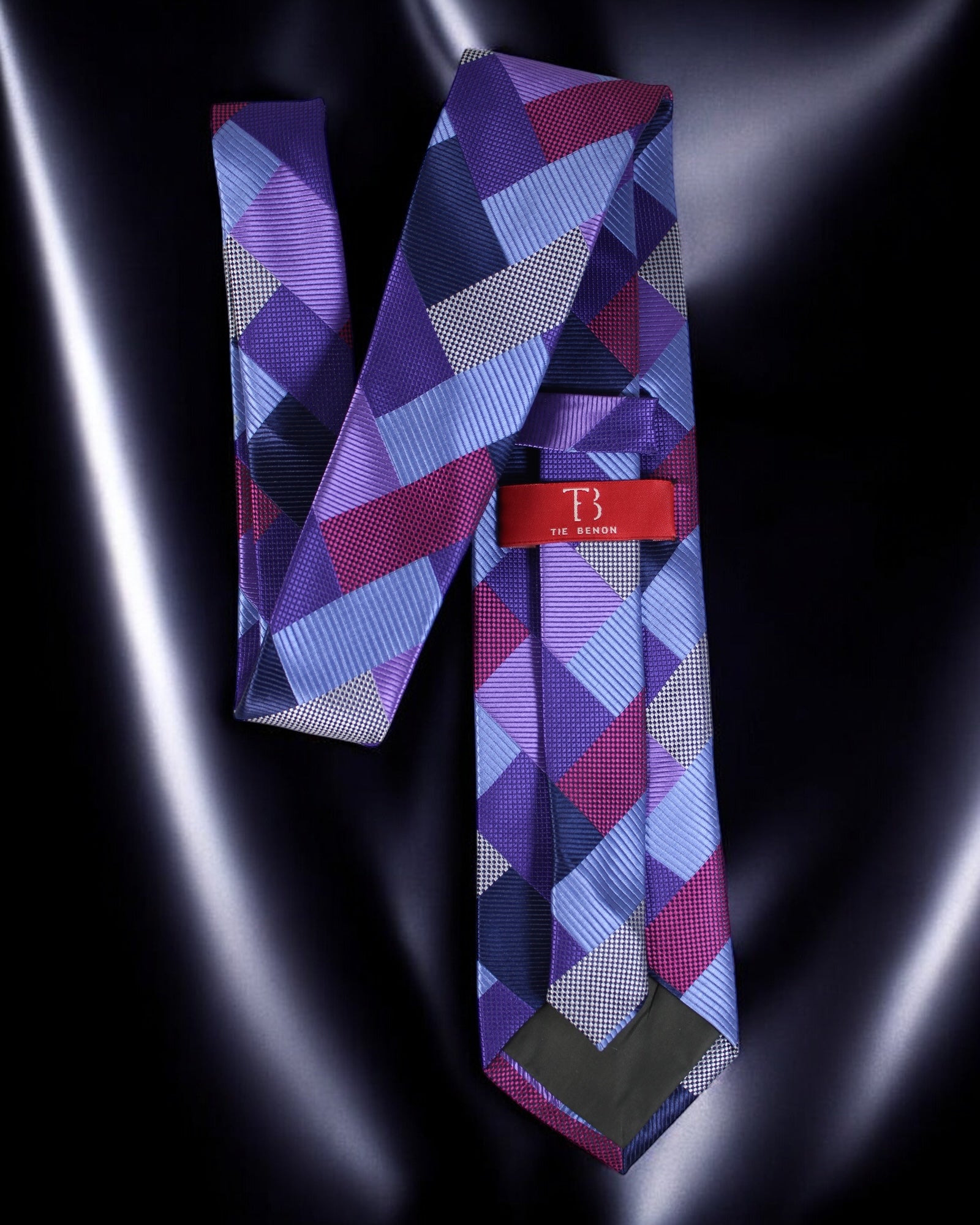 Patterned tie with a red label on a dark background Tie Benon