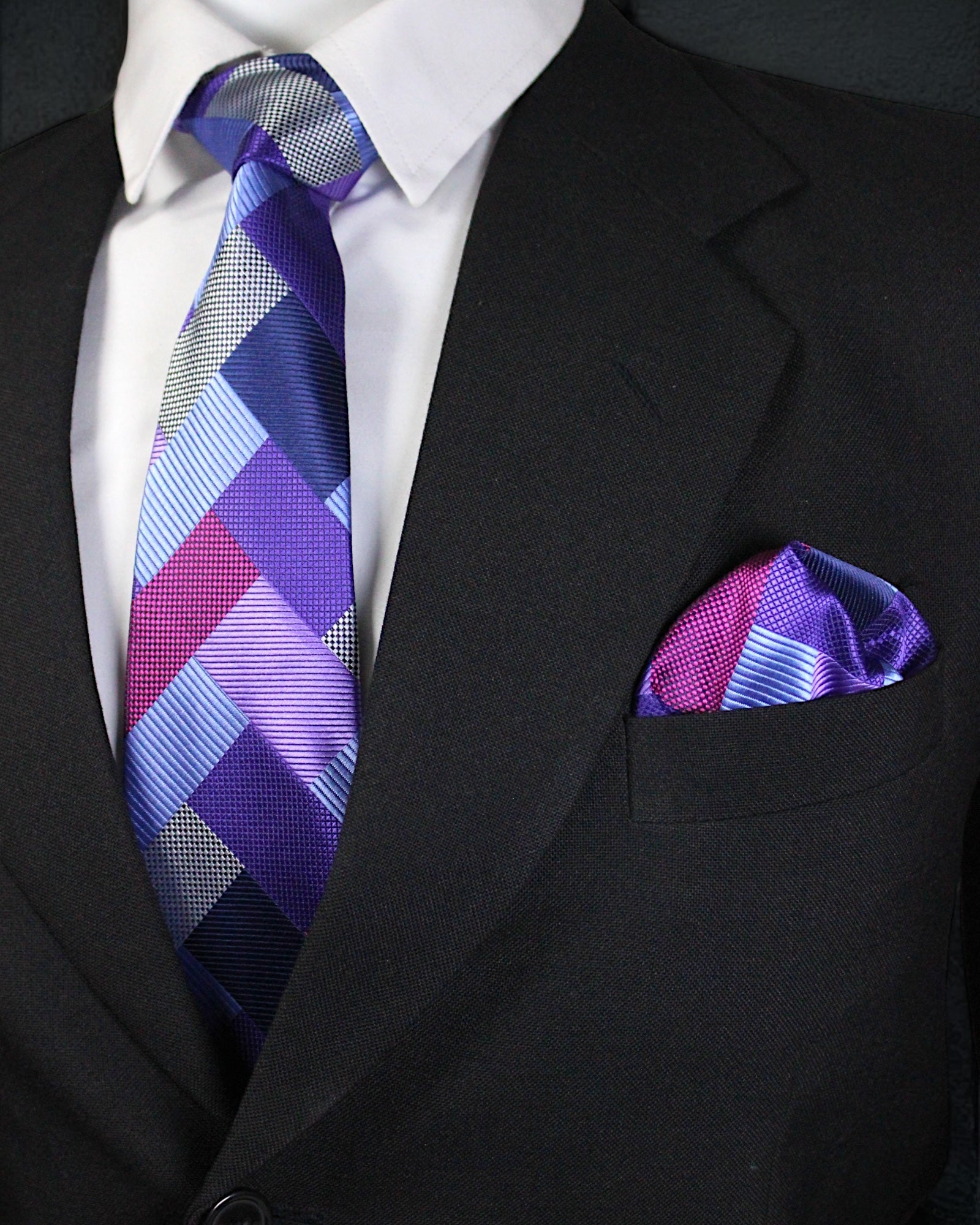 Black suit with a patterned purple tie and pocket square Tie Benon