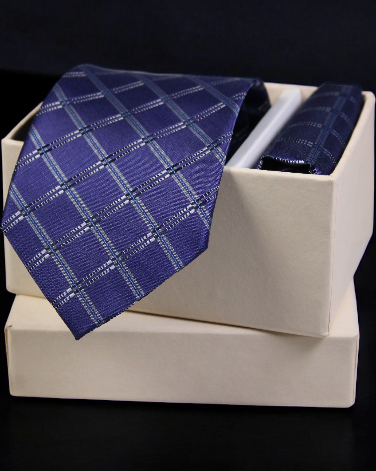 Blue checkered tie in a white box with a black background tie benon