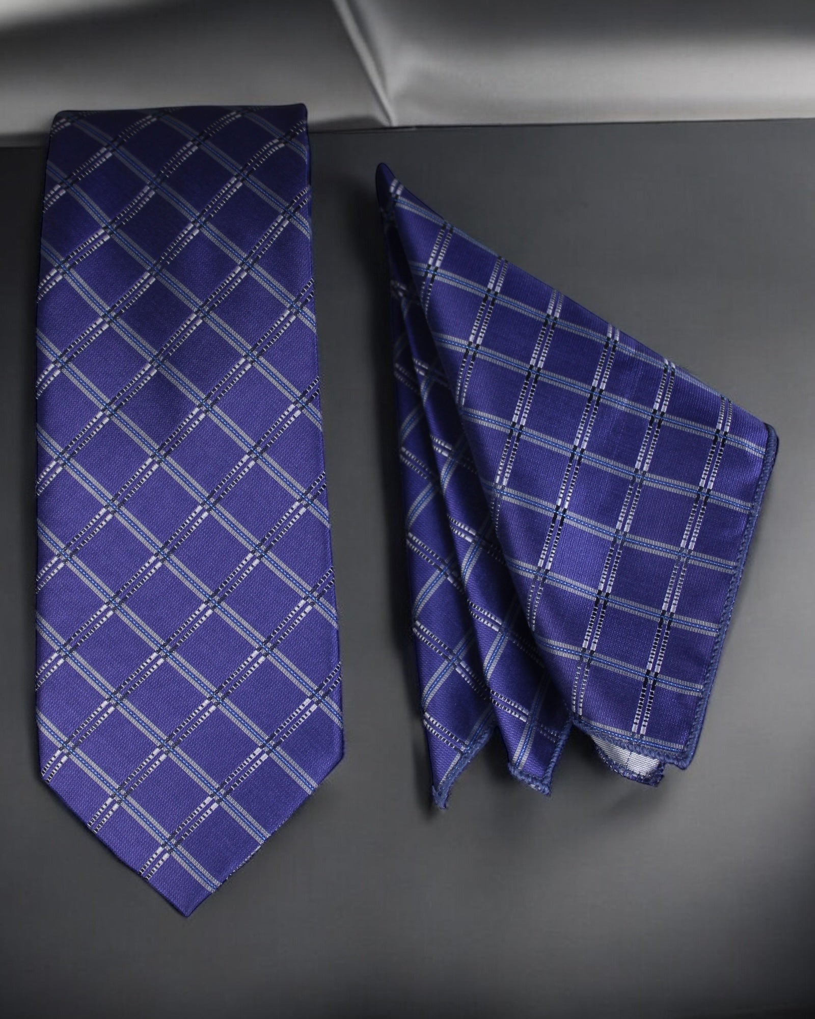 Blue checkered tie and pocket square on a dark surface Tie Benon