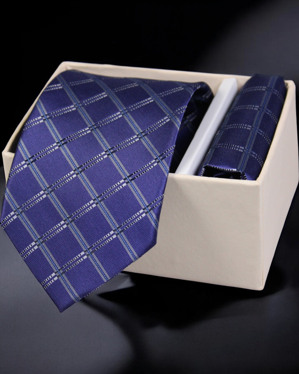 Blue checkered tie in a white box on a dark background Tie Benon