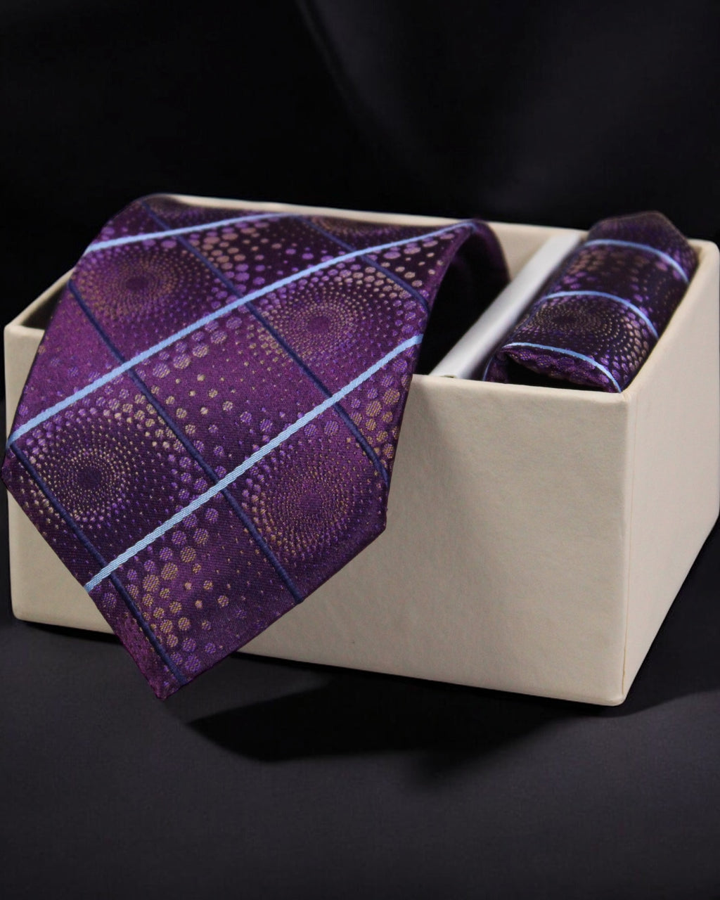 Purple patterned tie and pocket square set in a beige box on a black background Tie Benon