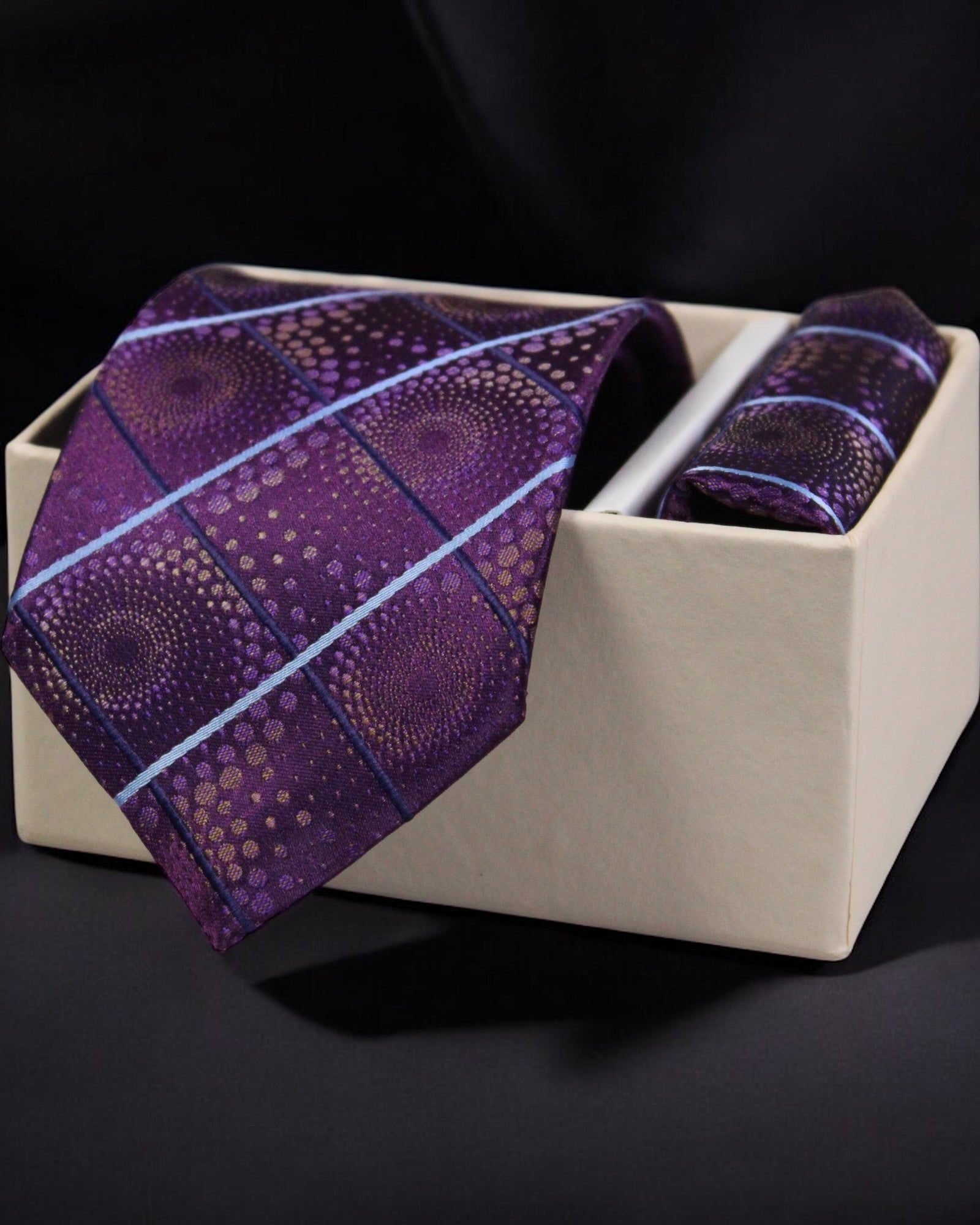 Purple patterned tie and pocket square set in a beige box on a black background Tie Benon