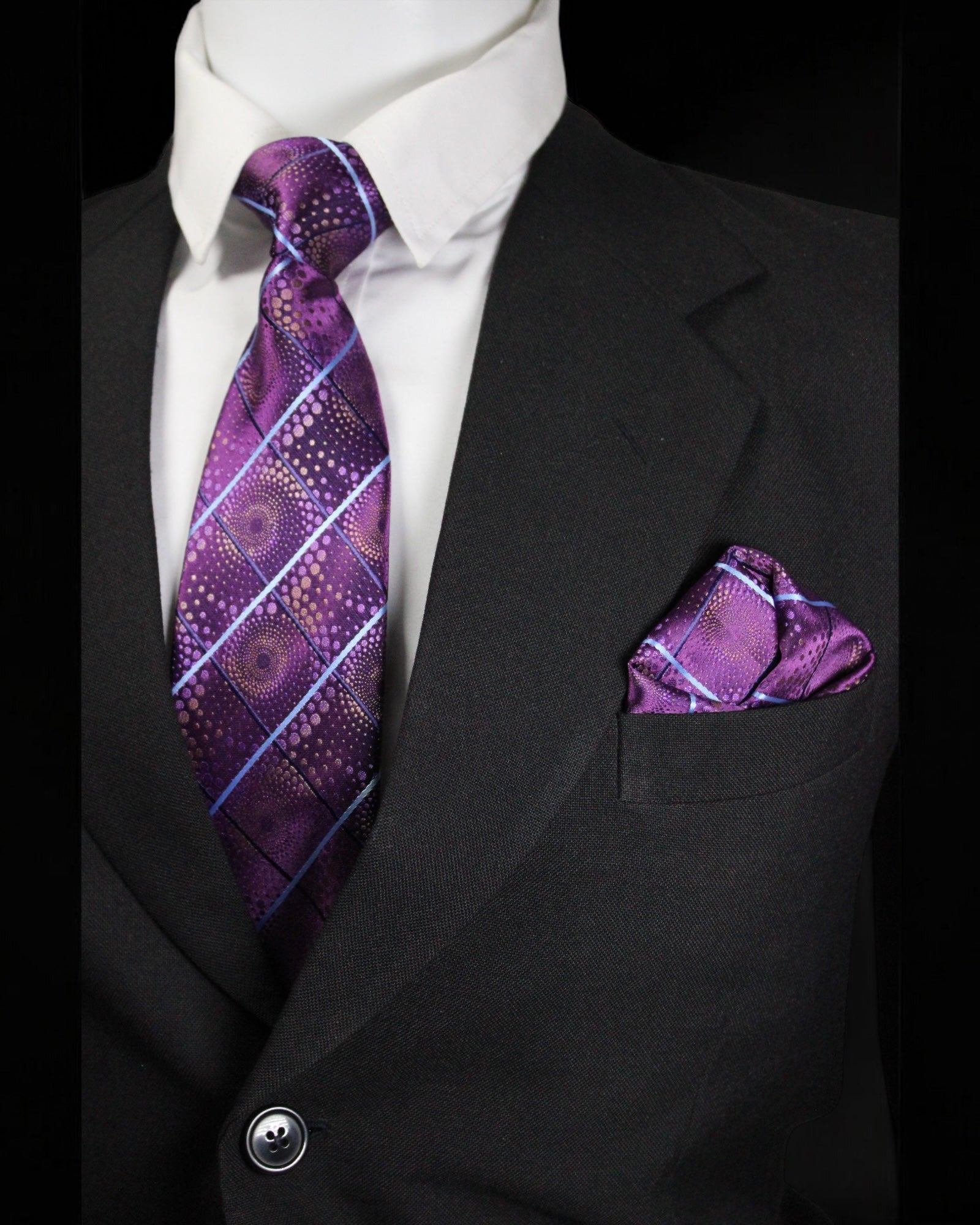 Black suit with purple patterned tie and pocket square on a black background Tie Benon