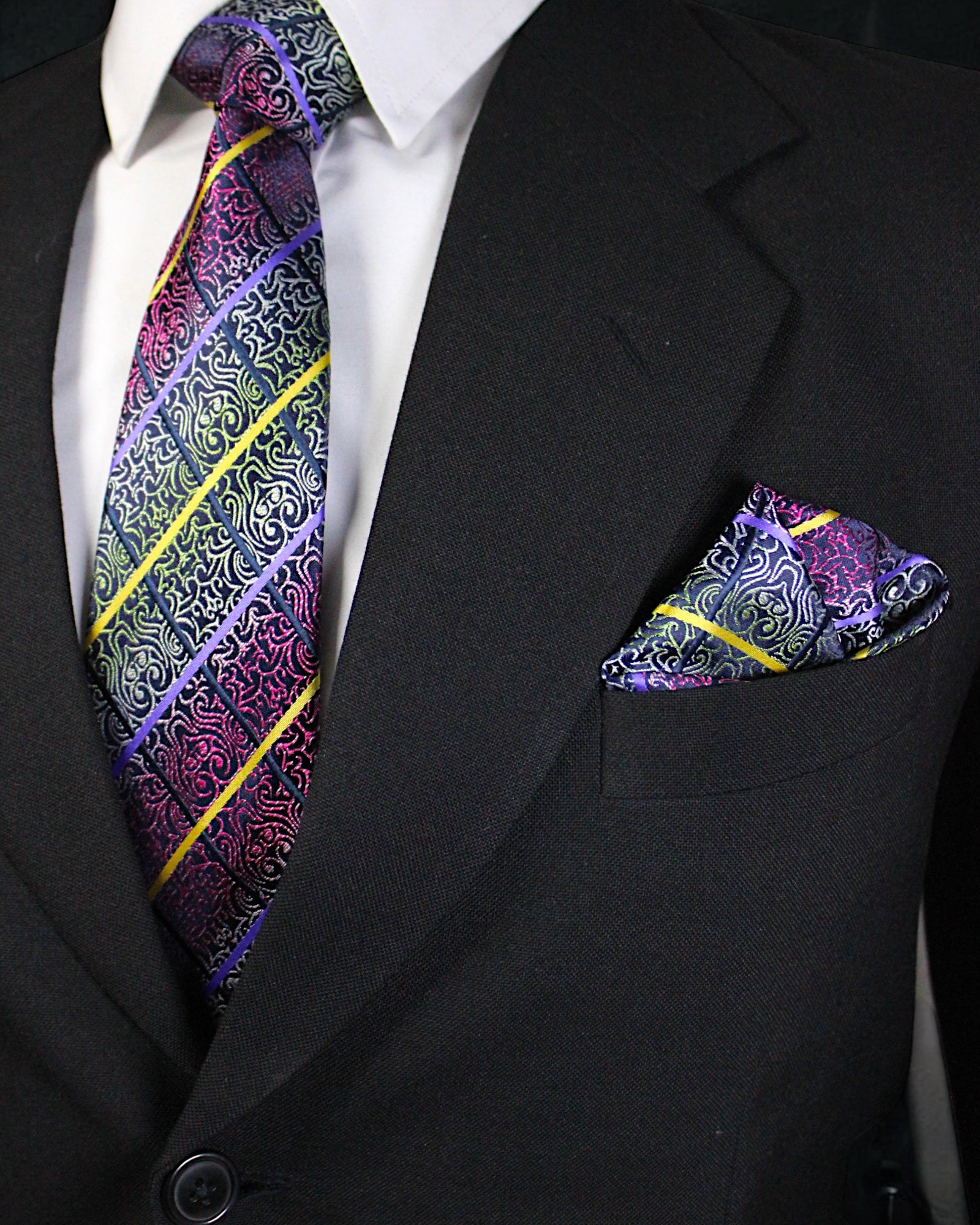 Black suit with a colorful paisley tie and pocket square Tie Benon